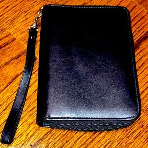 Black planner/organizer with zippered closure, wallet slot, addresses, goals